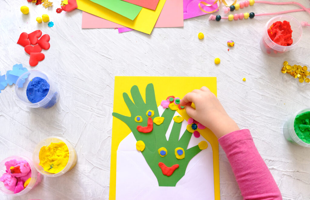 A girl making a home made greeting card as part of a childrens occupational therapy activity