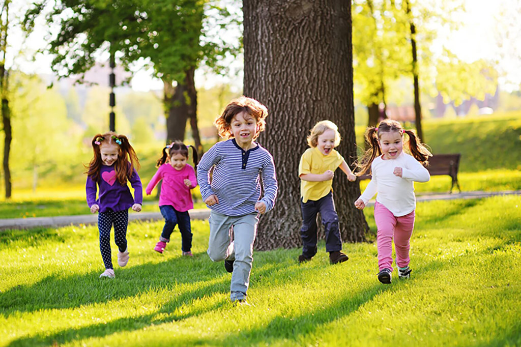 Kids running in a park playing