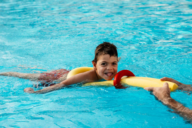 A child with a disability in a hydrotherapy program. Childrens physiotherapists may prescribe hydrotherapy to build strength and flexibility and for rehabilitation purposes.